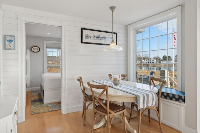 6 Brooks St, Kennebunkport, ME 04046 - dining room with light wood-style flooring, wood walls, and a water view