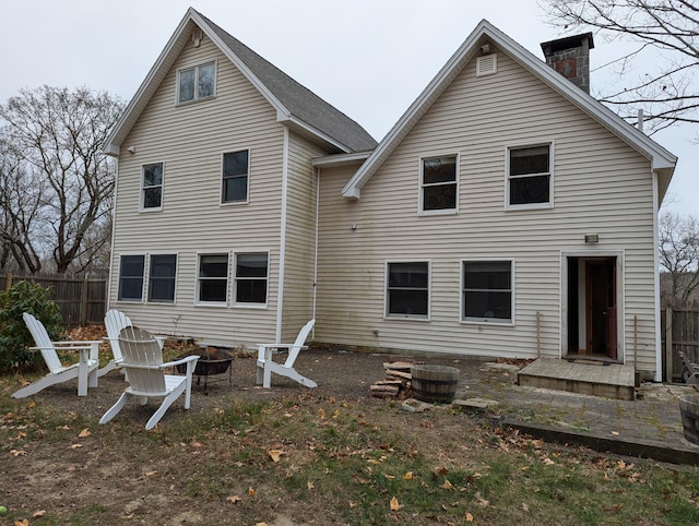 rear view of house featuring an outdoor fire pit