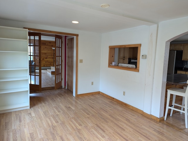 empty room with light hardwood / wood-style flooring