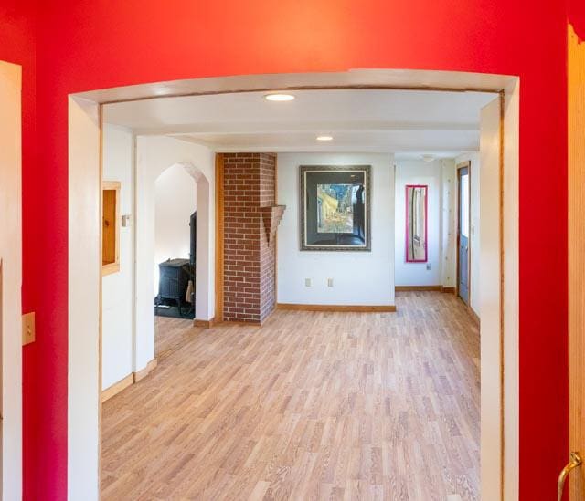 1 Branch St, Camden, ME 04843 - unfurnished living room featuring light wood-style floors and arched walkways