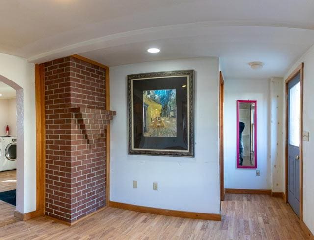 1 Branch St, Camden, ME 04843 - hall featuring washer / dryer, light wood-style flooring, and arched walkways