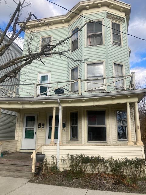 view of front of home featuring covered porch and a balcony