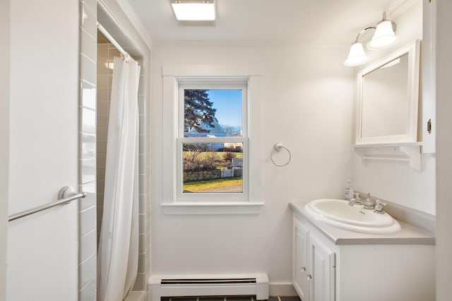 bathroom with baseboard heating, vanity, and walk in shower