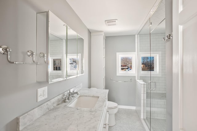 bathroom with toilet, an enclosed shower, and vanity