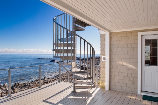 wooden deck with a water view