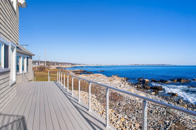 wooden terrace featuring a water view