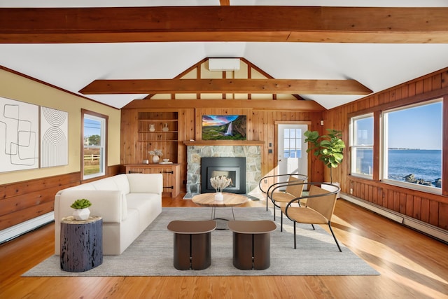 living room featuring a water view, a healthy amount of sunlight, and light hardwood / wood-style floors