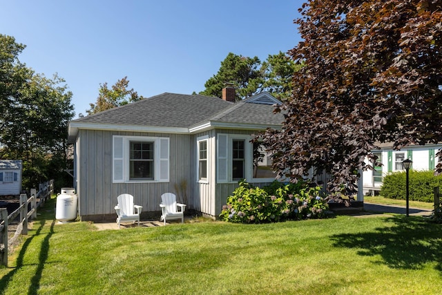 rear view of house featuring a lawn