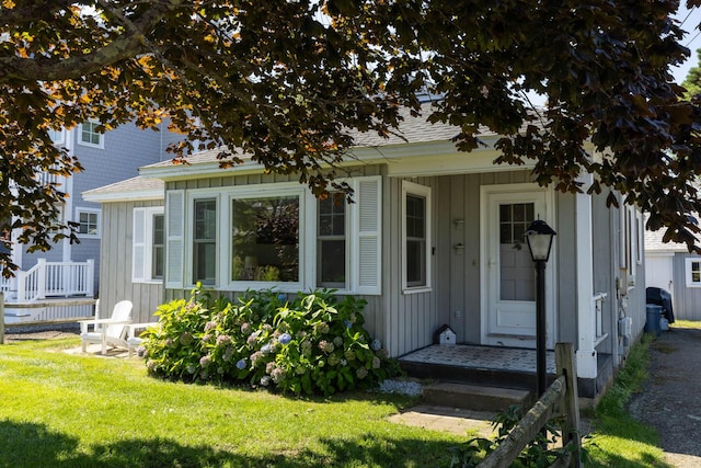 entrance to property featuring a lawn