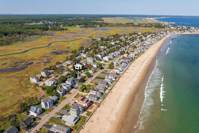 birds eye view of property with a water view and a view of the beach