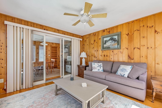 living room with ceiling fan and wood-type flooring