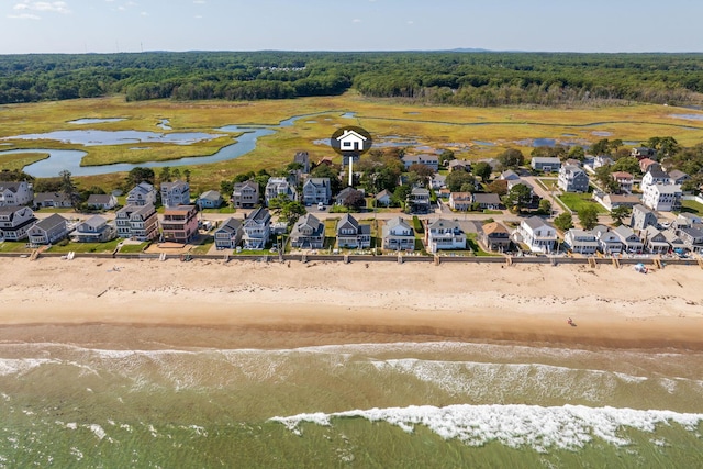 aerial view with a water view and a beach view