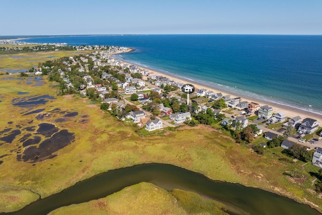 drone / aerial view featuring a water view and a beach view