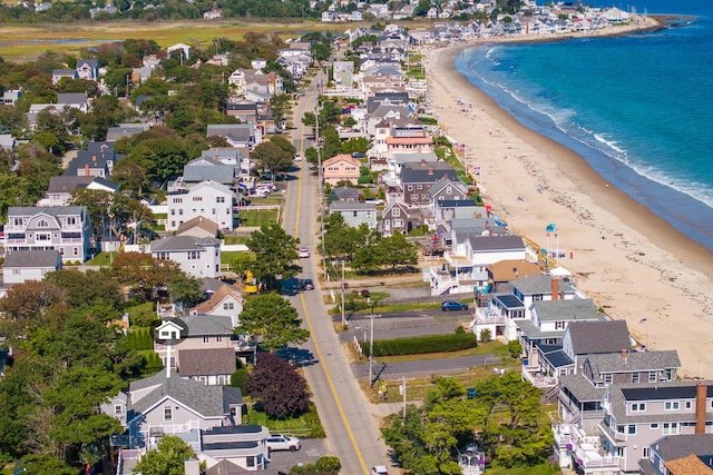 bird's eye view with a water view and a beach view