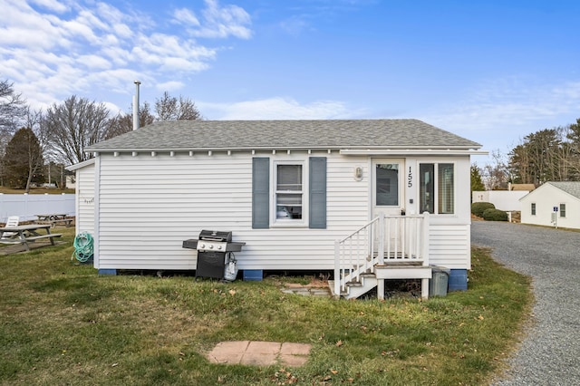 back of house featuring a yard