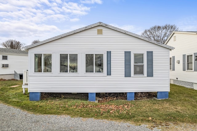 view of side of property with a yard