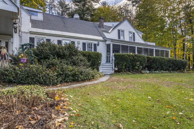 9 Dry Point Dr, Rome, ME 04963 - view of front facade with a sunroom and a front lawn
