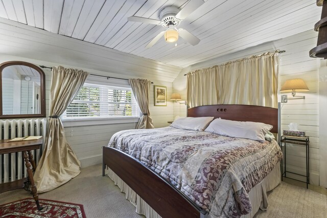 9 Dry Point Dr, Rome, ME 04963 - carpeted bedroom featuring ceiling fan, radiator heating unit, wood walls, lofted ceiling, and wood ceiling