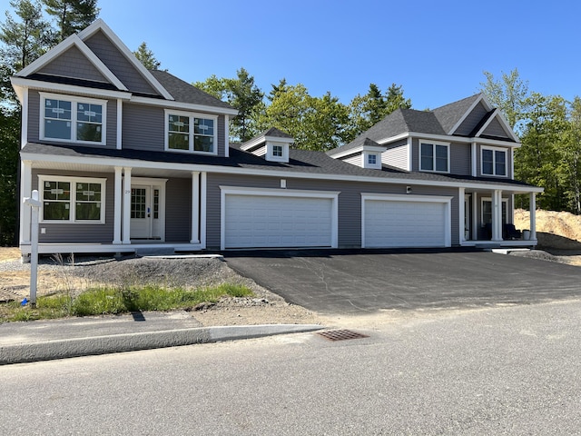 view of front facade with a garage, aphalt driveway, roof with shingles, and a porch