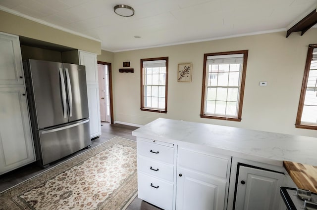 kitchen with white cabinets, stainless steel fridge, crown molding, and dark wood-type flooring