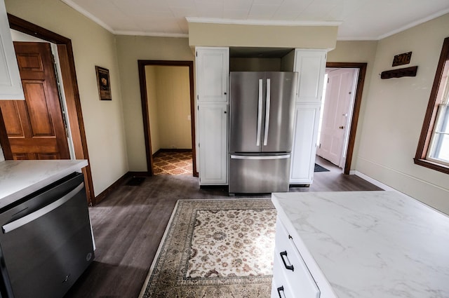 kitchen featuring white cabinets, dark hardwood / wood-style floors, ornamental molding, and appliances with stainless steel finishes