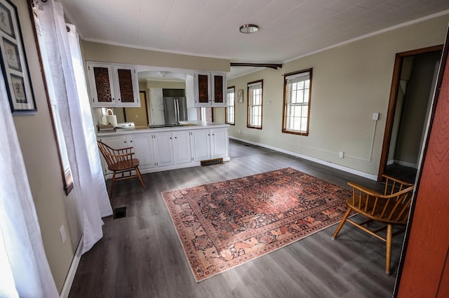 interior space with dark hardwood / wood-style floors and crown molding