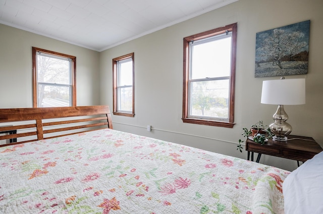 bedroom with multiple windows and ornamental molding