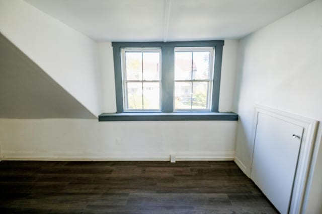 bonus room with dark hardwood / wood-style floors