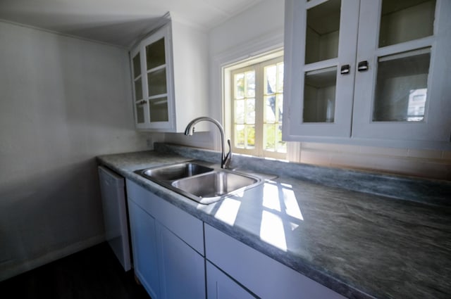 kitchen with white cabinets, stainless steel dishwasher, and sink