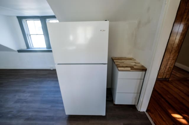 kitchen with white refrigerator and dark wood-type flooring