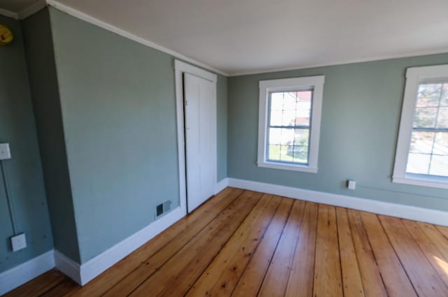 interior space with hardwood / wood-style flooring and crown molding