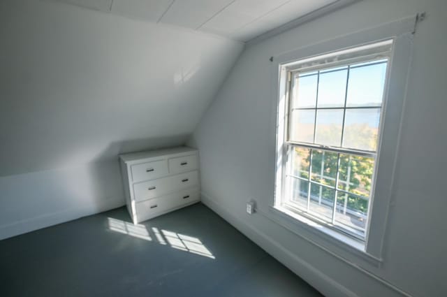 bonus room featuring plenty of natural light and vaulted ceiling