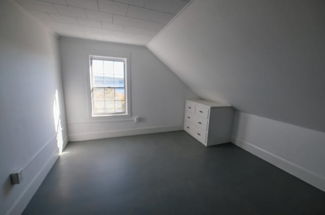 additional living space featuring lofted ceiling