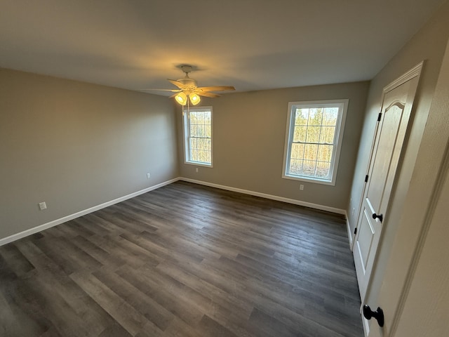 unfurnished bedroom featuring dark wood-type flooring and ceiling fan