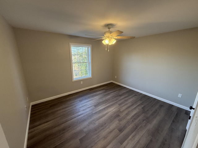 empty room featuring dark hardwood / wood-style floors and ceiling fan