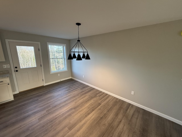 unfurnished dining area featuring dark wood-type flooring