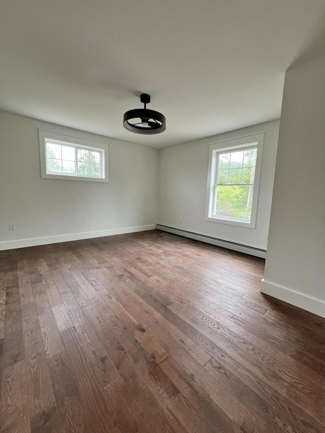 79 Pasture Ln, Brownfield, ME 04010 - empty room with a baseboard radiator, dark wood finished floors, and a ceiling fan