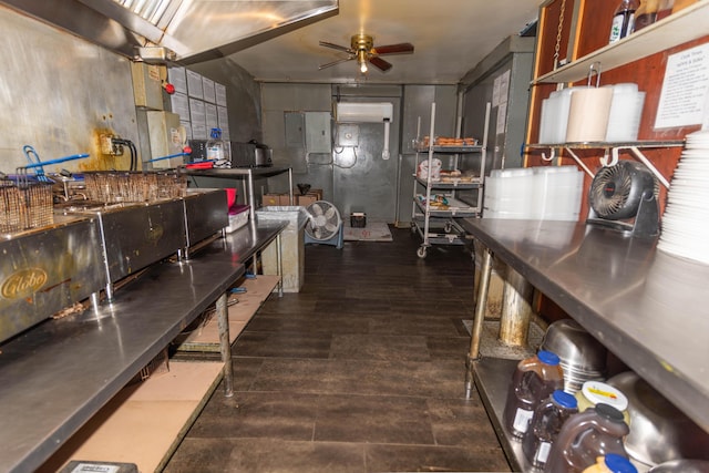 kitchen featuring electric panel, ceiling fan, a wall mounted air conditioner, and dark hardwood / wood-style floors