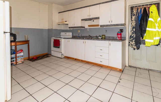 kitchen featuring white cabinets, light tile patterned flooring, white electric stove, and sink