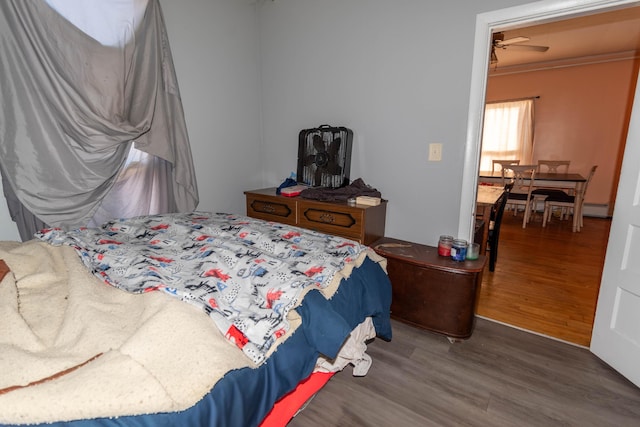 bedroom featuring hardwood / wood-style floors and crown molding