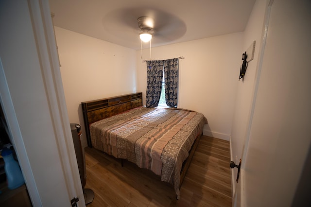 bedroom featuring ceiling fan and dark hardwood / wood-style flooring