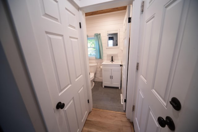 hall with light hardwood / wood-style floors and sink