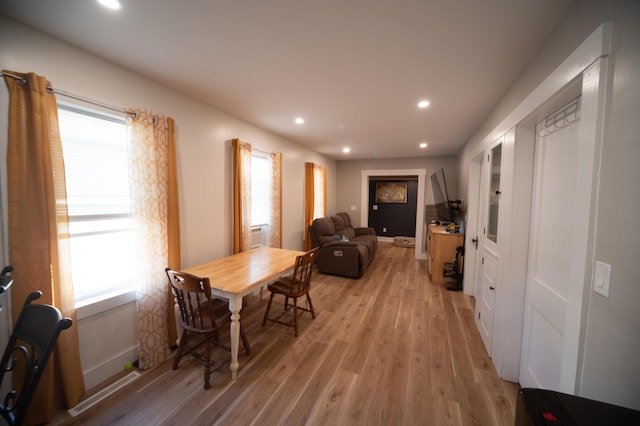 dining room featuring a wealth of natural light and light hardwood / wood-style flooring