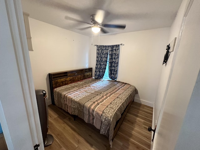 bedroom with ceiling fan and hardwood / wood-style floors