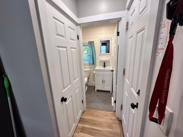 hallway featuring light hardwood / wood-style flooring and sink