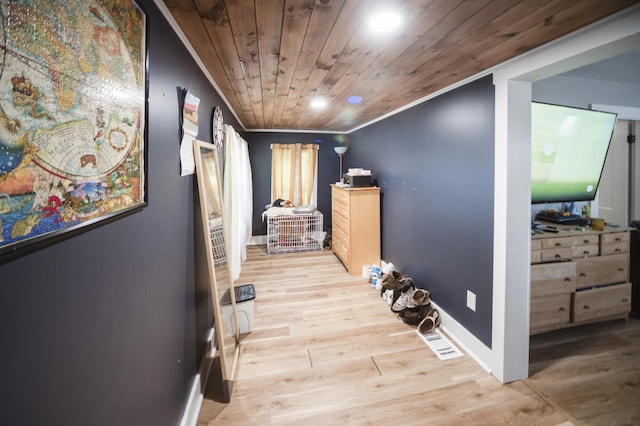 hall featuring light hardwood / wood-style floors, wooden ceiling, and ornamental molding