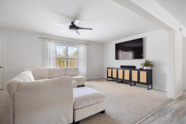 living room featuring light hardwood / wood-style flooring and ceiling fan