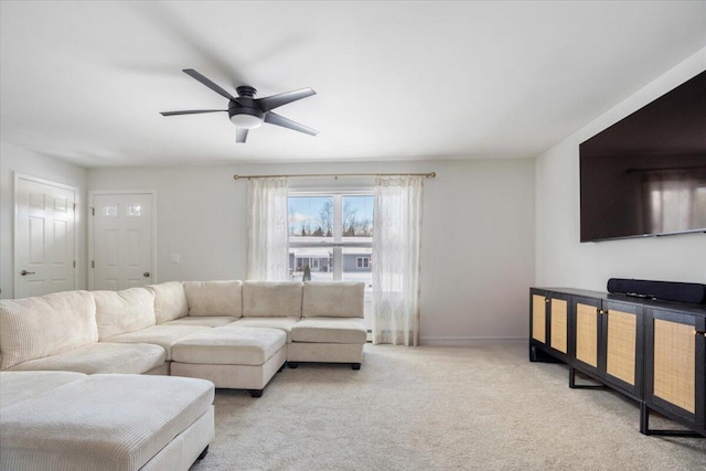 carpeted living room with ceiling fan