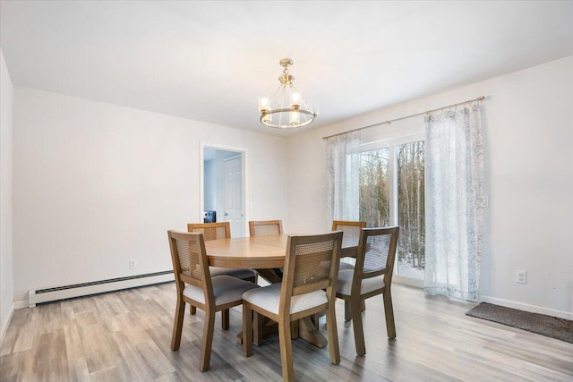 dining space with a chandelier, light wood-type flooring, and a baseboard radiator