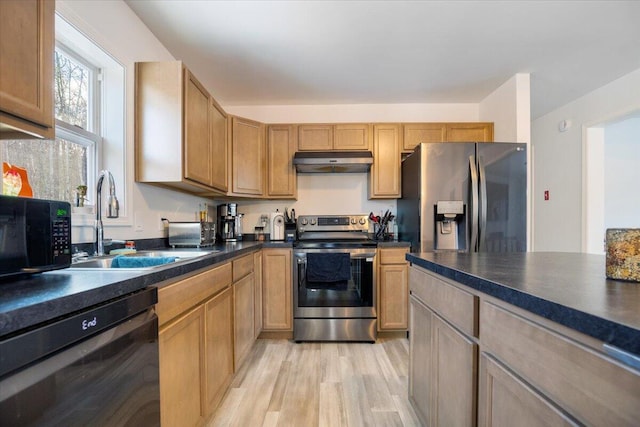 kitchen featuring black appliances, light wood-type flooring, and sink